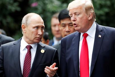 FILE PHOTO: U.S. President Donald Trump and Russia's President Vladimir Putin talk during the family photo session at the APEC Summit in Danang, Vietnam November 11, 2017. REUTERS/Jorge Silva/File Photo
