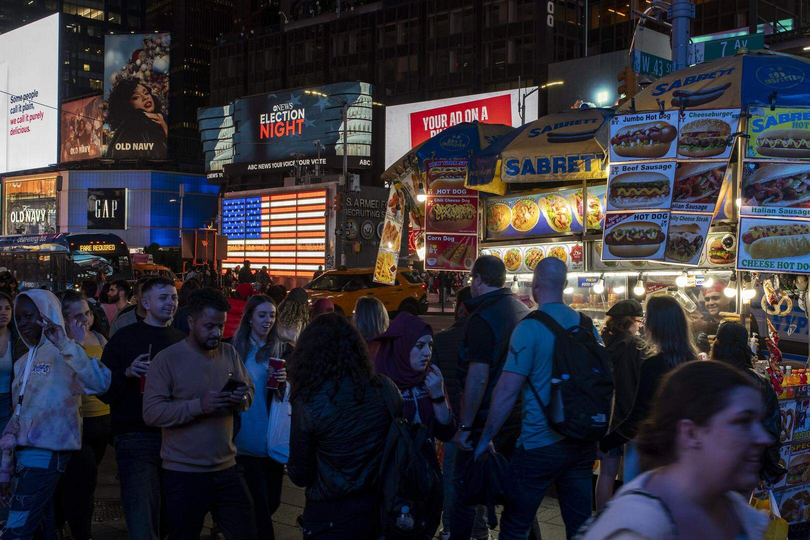 People visit Times Square as election results are displayed on news tickers in New York, Tuesday, Nov. 5, 2024. America’s economic growth is the envy of its global counterparts but voters wanted more from the Biden administration — specifically, lower prices. (Karsten Moran/The New York Times)