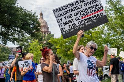AUSTIN, TEXAS - AUGUST 04: People protest against the recently introduced redistricting legislation during an emergency march and picket rally outside of the Governor's Mansion on August 04, 2025 in Austin, Texas. A crowd gathered to protest the ongoing redistricting proposal, which has garnered nationwide attention, during a special session in the Texas legislature. Texas Democratic lawmakers have fled the state in an attempt to protest and deny the proposed plan. Gov. Greg Abbott has threatened to remove lawmakers who do not return by today.   Brandon Bell/Getty Images/AFP (Photo by Brandon Bell / GETTY IMAGES NORTH AMERICA / Getty Images via AFP)