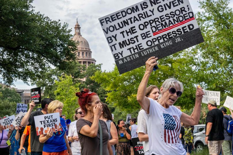 AUSTIN, TEXAS - AUGUST 04: People protest against the recently introduced redistricting legislation during an emergency march and picket rally outside of the Governor's Mansion on August 04, 2025 in Austin, Texas. A crowd gathered to protest the ongoing redistricting proposal, which has garnered nationwide attention, during a special session in the Texas legislature. Texas Democratic lawmakers have fled the state in an attempt to protest and deny the proposed plan. Gov. Greg Abbott has threatened to remove lawmakers who do not return by today.   Brandon Bell/Getty Images/AFP (Photo by Brandon Bell / GETTY IMAGES NORTH AMERICA / Getty Images via AFP)