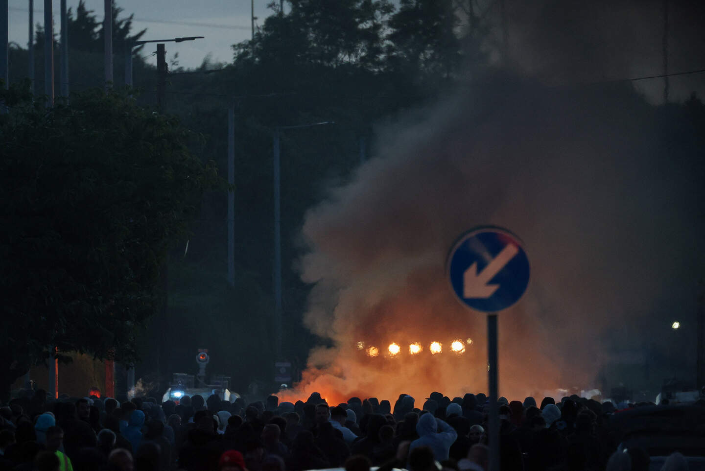 Smoke rises as anti-immigrant protesters demonstrate, following a knife attack on June 8, which left a man seriously injured and prompted police to declare a critical incident, in Belfast, Northern Ireland, June 10, 2026. REUTERS/Isabel Infantes