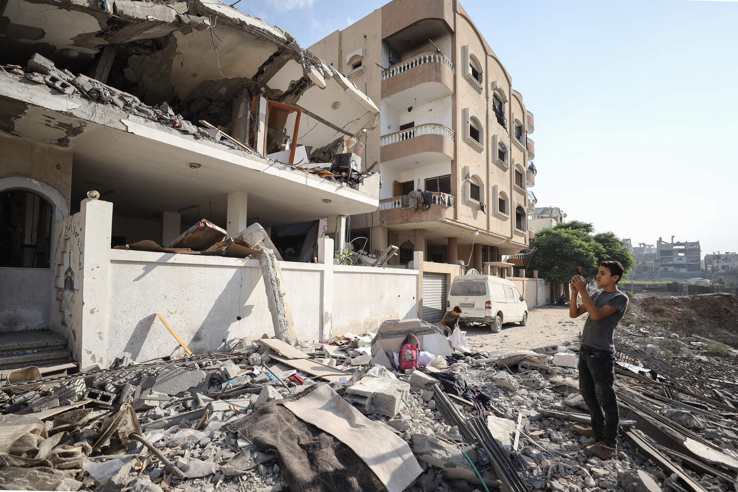 Inwoners bij een gebombardeerd gebouw in Gaza-Stad.