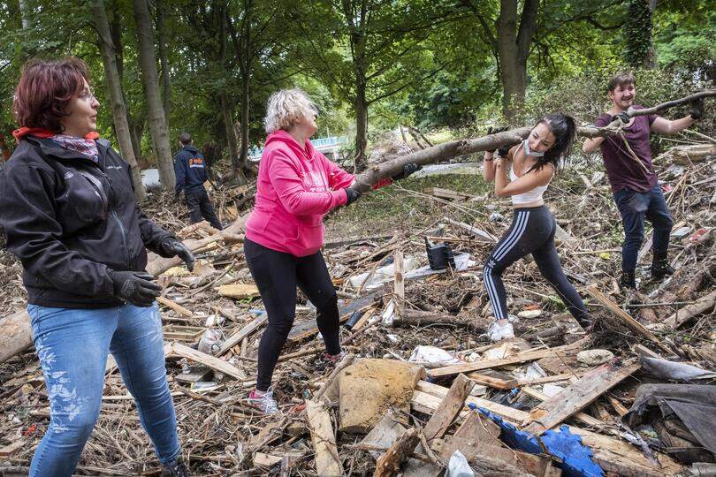 Gewone mensen helpen puinruimen na de overstromingen van de Vesder nabij Trooz.