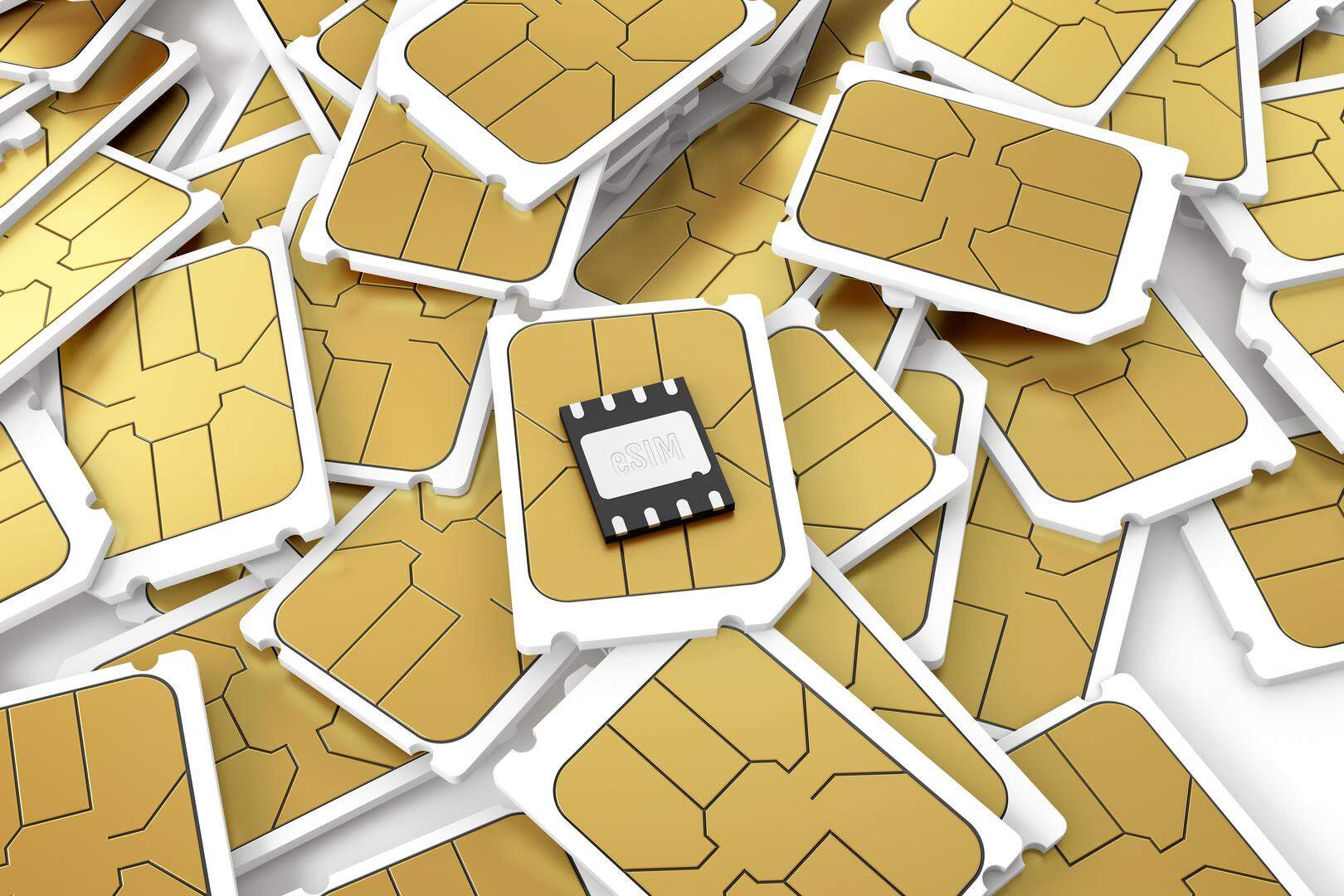 Embedded SIM laying on a pile of micro SIM cards.