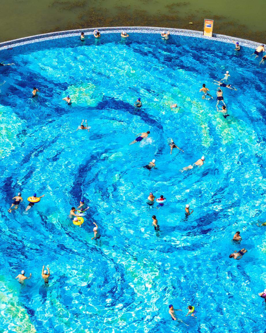 CHENGDU, CHINA - JUNE 21: Aerial view of the Jiangtan Park infinity pool, presenting a mesmerizing scene reminiscent of Van Gogh's "Starry Night," on June 21, 2025 in Chengdu, Sichuan Province of China. The shimmering lights reflect on the water, creating a magical atmosphere that captivates all who visit. (Photo by VCG/VCG via Getty Images)