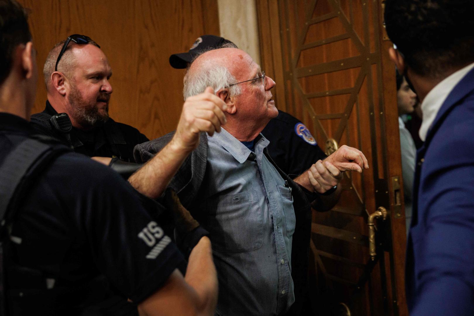 WASHINGTON, DC - MAY 14: Ben Cohen, co-founder of Ben and Jerry's, is detained by U.S. Capitol Police for disrupting proceedings during a hearing with U.S. Secretary of Health and Human Services Robert F. Kennedy Jr. before the Senate Committee on Health, Education, Labor, and Pensions on Capitol Hill on May 14, 2025 in Washington, DC. Kennedy is testifying before the Senate Committee on the Department of Health and Human Services' proposed 2026 fiscal year budget.   Samuel Corum/Getty Images/AFP (Photo by Samuel Corum / GETTY IMAGES NORTH AMERICA / Getty Images via AFP)