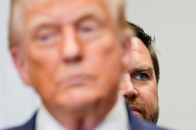 FILE PHOTO: U.S. Vice President JD Vance looks on from behind President Donald Trump during an event at the Roosevelt Room of the White House in Washington, D.C., U.S., July 31, 2025. REUTERS/Kent Nishimura/File Photo