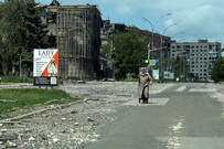 FILE PHOTO: A resident walks at a street near buildings damaged by Russian military strikes, amid Russia's attack on Ukraine, in the frontline town of Pokrovsk, Donetsk region, Ukraine May 21, 2025. REUTERS/Anatolii Stepanov/File Photo