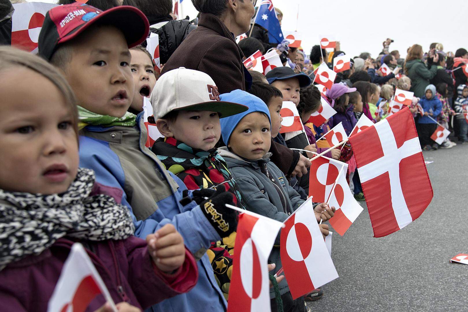 epa04346195 Locals holding Danish flags wait to welcome and greet the Danish Crown Couple family in Nuuk, Greenland, 08 August 2014, where they are greeted by locals. The Danish Royal Family is on an official visit in Greenland until 08 August.  EPA/KELD NAVNTOFT DENMARK OUT
