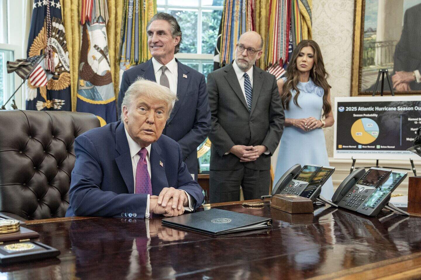 De Amerikaanse president Donald Trump met achter hem Russell Vought (m.).