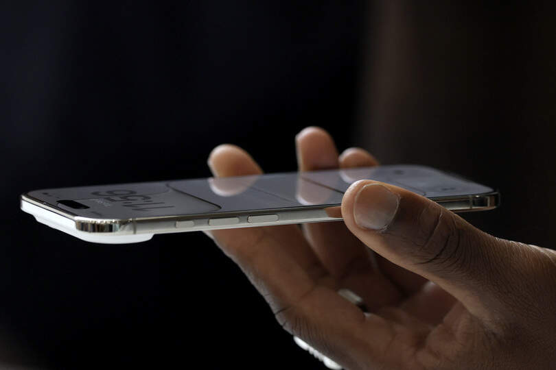 CUPERTINO, CALIFORNIA - SEPTEMBER 09: An attendee inspects a new Apple iPhone Air during an Apple special event at Apple headquarters on September 9, 2025 in Cupertino, California. Apple unveiled a new generation of iPhones, updated Apple Watches, and AirPods during a special event at its headquarters.   Justin Sullivan/Getty Images/AFP (Photo by JUSTIN SULLIVAN / GETTY IMAGES NORTH AMERICA / Getty Images via AFP)
